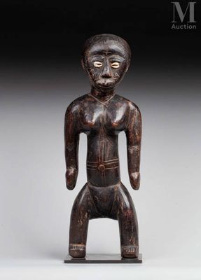 a wooden statue of a man with a hat on his head