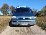 a blue van that is parked on the side of the road