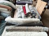 many rolls of fabric on a pallet in a warehouse