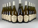 six bottles of wine are lined up in a row on a table