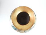 a vase with a gold rim on a white table