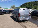 a silver van that is parked in a parking lot
