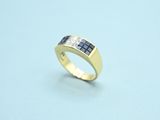 an image of a gold ring with blue sapphires