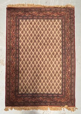 a brown and red rug hanging on a wall next to a white wall