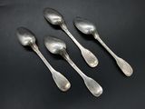 five silver spoons on a black surface with a black background