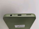 the back of a green cell phone with a sticker on it