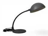 a close up of a desk lamp on a white surface
