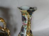 two vases that have been decorated with gold and blue designs