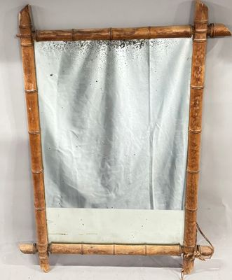 mirror with bamboo frame and mirror hanging on a white wall
