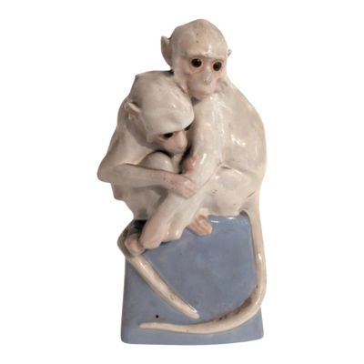 a figurine of a monkey holding a baby monkey