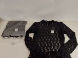 the shirt is black and has a lace pattern on it