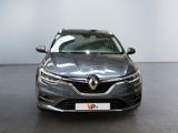 the front view of a grey car parked in a showroom