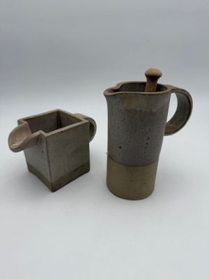 pair of vintage stoneware coffee pots with wooden handles
