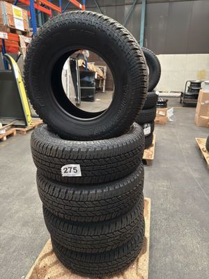 four tires stacked on pallets in a warehouse
