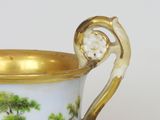 a vase with a handle that has a painting on it