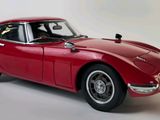 an image of a red model car on a white background