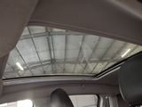 a view of the inside of a car with the sun shining through the roof