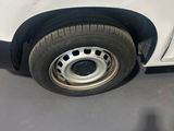 a white truck with a flat tire parked in a parking lot