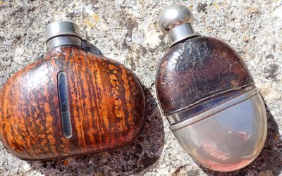 two bottles that are sitting on the ground