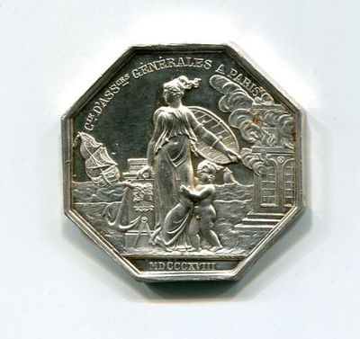 une pièce d'argent sur laquelle figurent une femme et un enfant