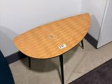 a small table with a laptop on it in a corner