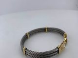 a close up of a bracelet on a white surface