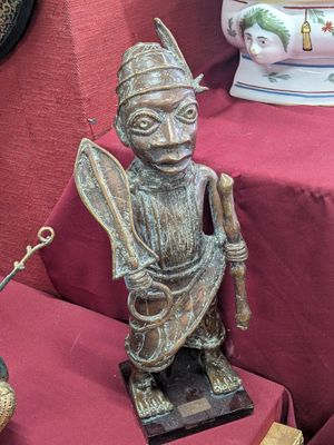 a statue of a man that is sitting on a table