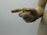 a statue of a woman holding a piece of bread