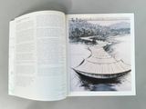 an open book with a drawing of a boat on the water