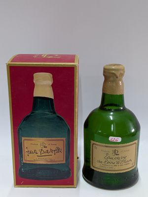a bottle of liquor next to a box on a table