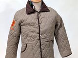 a jacket on a mannequin stand with a tie on it