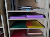 a lot of folders on the shelves in the room