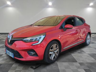 a red car is parked in a room with a checkered floor