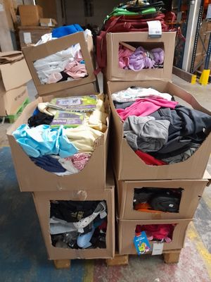 several boxes of clothing are stacked on top of each other in a warehouse