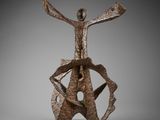 an image of a bronze sculpture of a man with arms outstretched