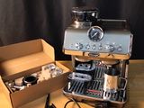 a coffee machine and a box of coffee on a table