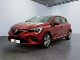 une voiture rouge dans une pièce blanche au sol noir
