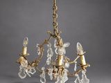 a brass and crystal chandelier with four lights