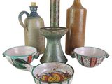many different types of vases and bowls on the table