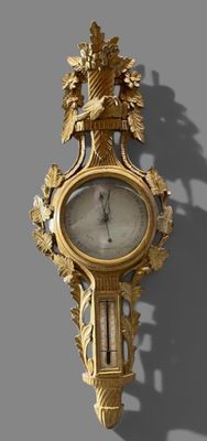 a gold clock on the wall with a bird on it