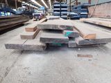 several pieces of wood are stacked on top of each other in a warehouse