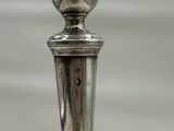 a silver candle that is sitting on top of a table