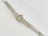 wrist watch on a white surface with a white background