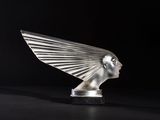 a sculpture of a woman ' s head with wings on a black surface