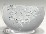 a glass bowl with water inside of it on a table