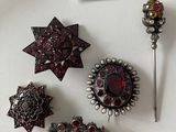 several pieces of jewelry are displayed on a white surface with a price tag