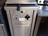 stainless steel counter top with a stove and oven in a commercial kitchen