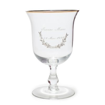 a wine glass with a gold rim on a white background