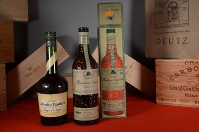 several bottles of wine are sitting on a table next to a box