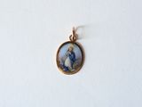 an image of a gold plated pendant with a picture of the virgin mary and child jesus